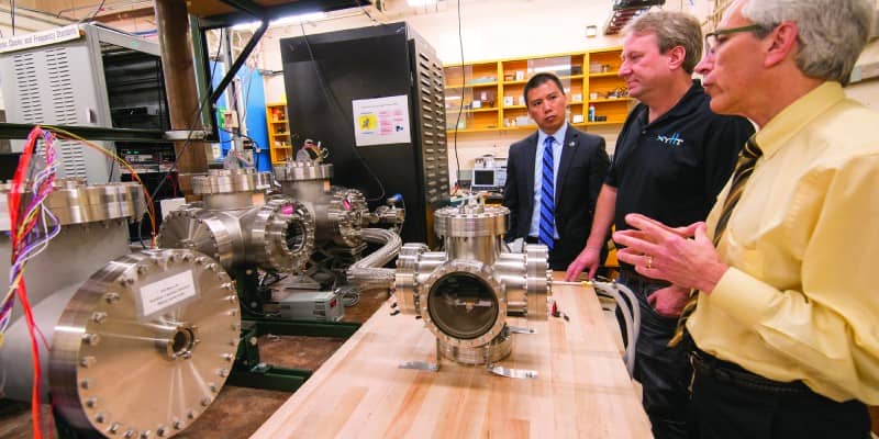 In the atomic clock laboratory with Dr. Villahermosa (left), the author (center), and Dr. James Camparo, Aerospace Fellow, Electronics and Photonics Laboratory (right)