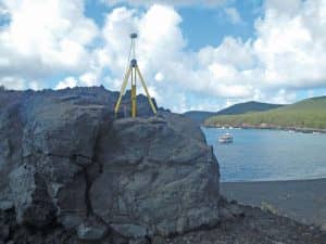 GPS equipment is set up over mark PAGAN 1 (PID AA5095) on the remote volcanic island of Pagan, Commonwealth of the Northern Mariana Islands, during a recent NGS survey aimed at determining the rotation of the Mariana tectonic plate for the purposes of defining MATRF2022.