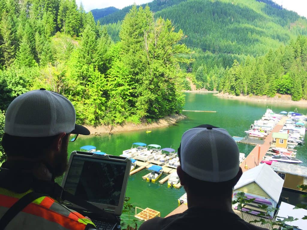 A two-person survey crew (the author at left and Jason Churchill) operate their CEE-USV remote boat from a vantage point at Detroit Lake Marina, OR.