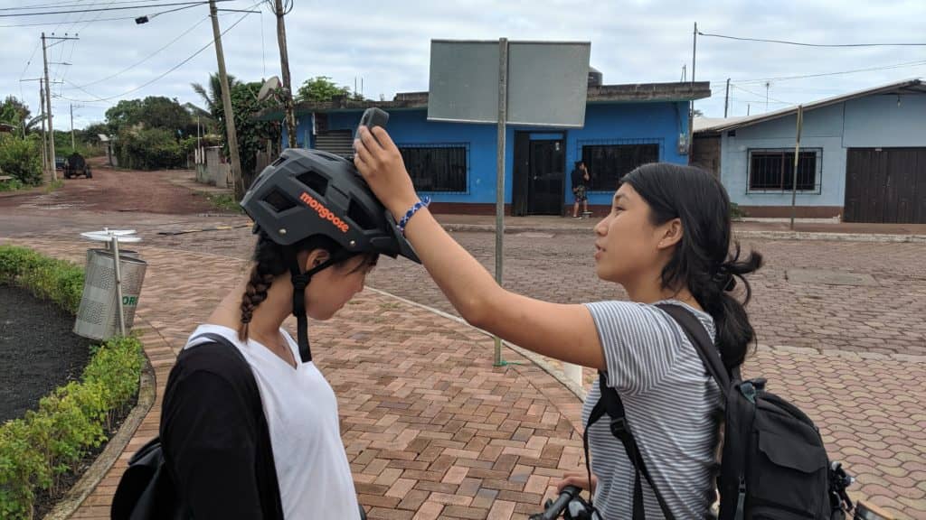 Amy Tian installs the 360° camera on top of Jein Park’s helmet before capturing street imagery on bi ke. © Chris Beddow