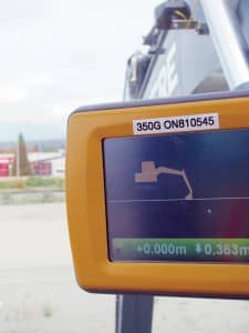 This heavy excavator (left) resolves orientation via GNSS antennas on the counterweight, and a series of tilt sensors calibrated to the moving sections of the boom provide highly accurate feedback to the operator (inset) as to progress of the bucket towards design grades per the 3D model uploaded into the controller. Another level of productivity gains comes from the telemetry fed into the site-management software and its virtual-reality viewing tools that provide real-time visual status of all equipment on the site.  