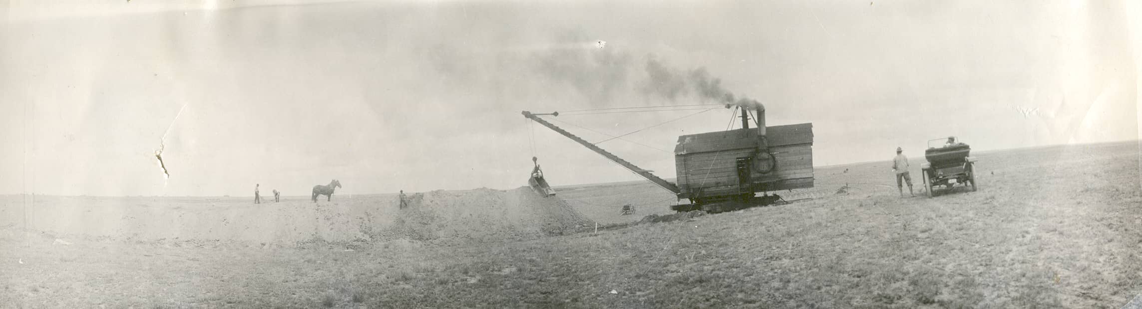 Steam shovel – horses – old car