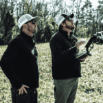 Jeff Davis (left) and Nick Tucker (right) monitor the mdLiDAR1000 as it collects data during the Big Creek surveying mission.